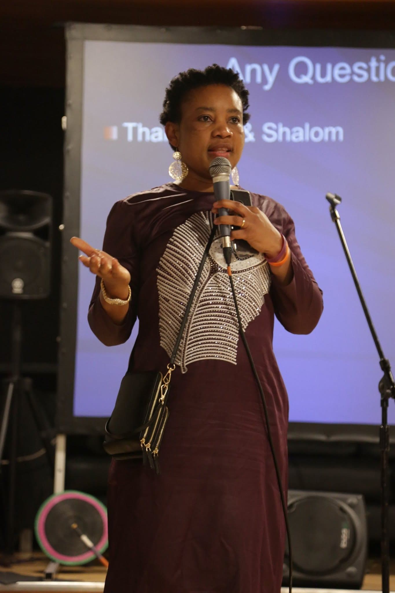 A speaker taking questions from the audience at a community talk