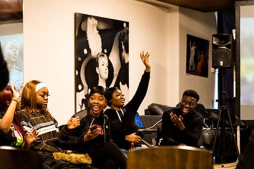 A group of young people laughing together at a Coventry Diversity Forum event